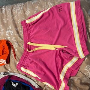Nike Pink Athletic Shorts with Yellow Stripes